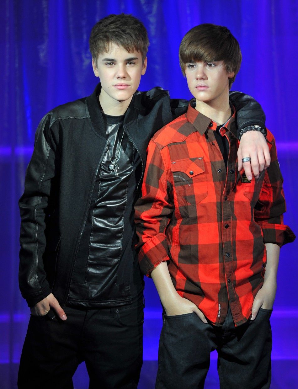 Justin Bieber strikes a pose with a waxwork model of himself during the official unveiling at Madame Tussauds museum in London.