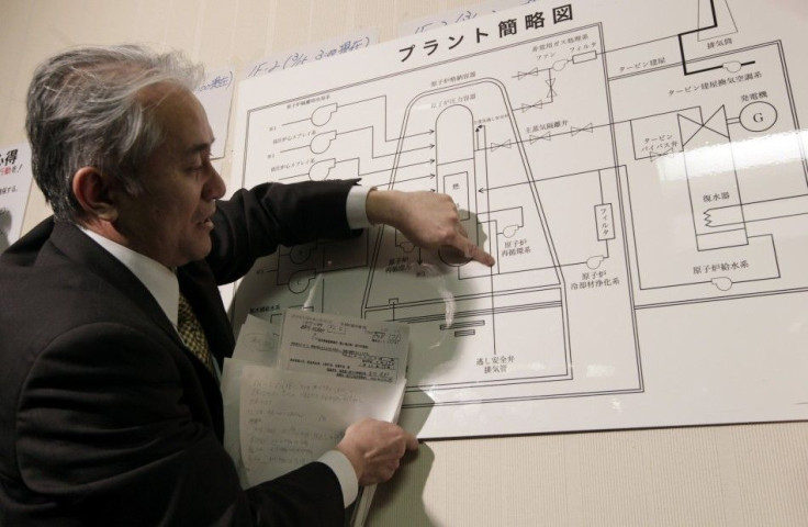 A Tokyo Electric Power official points at an illustration of a nuclear plant as he answers reporters' questions at the disaster center in Fukushima, northern Japan March 15, 2011.