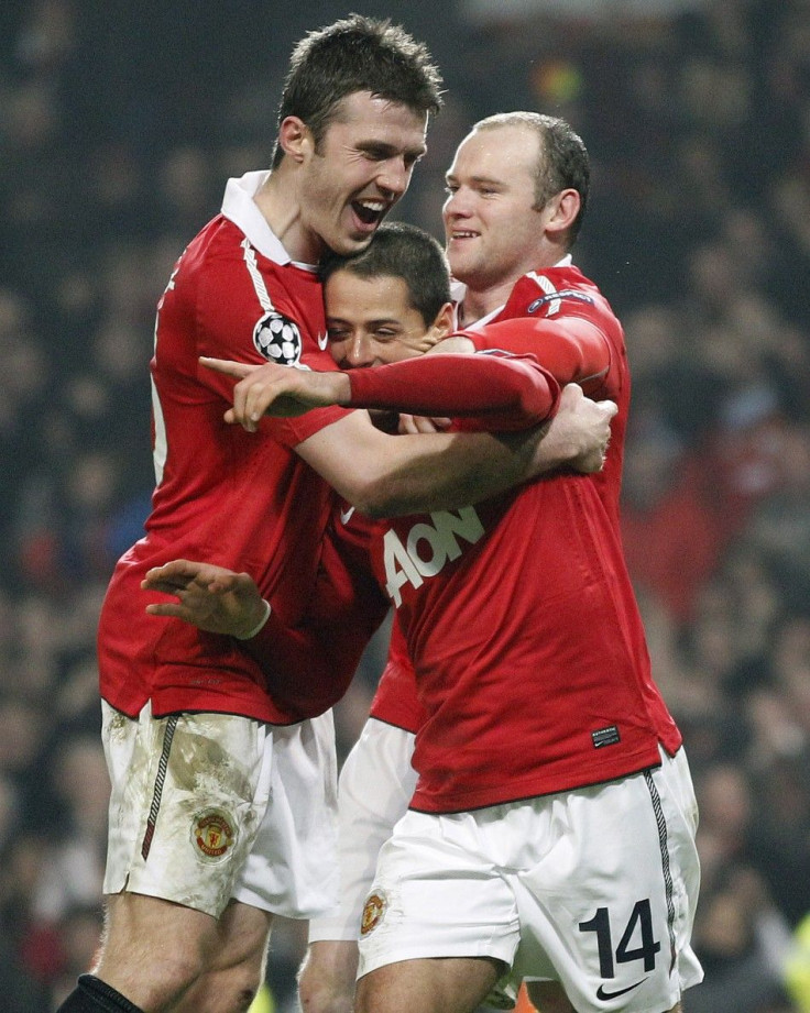 Manchester United's Hernandez celebrates with Rooney and Carrick after scoring during their second leg round of sixteen Champions League soccer match against Olympique Marseille at Old Trafford in Manchester.