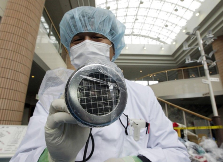 Medical staff use a Geiger counter 