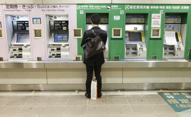 A man buys a bullet train ticket at a station in Tokyo March 16, 2011.