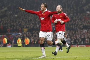 Manchester United's Hernandez celebrates with Rooney after scoring during their second leg round of sixteen Champions League soccer match against Olympique Marseille at Old Trafford in Manchester.