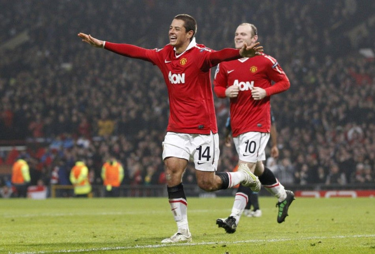 Manchester United's Hernandez celebrates with Rooney after scoring during their second leg round of sixteen Champions League soccer match against Olympique Marseille at Old Trafford in Manchester.