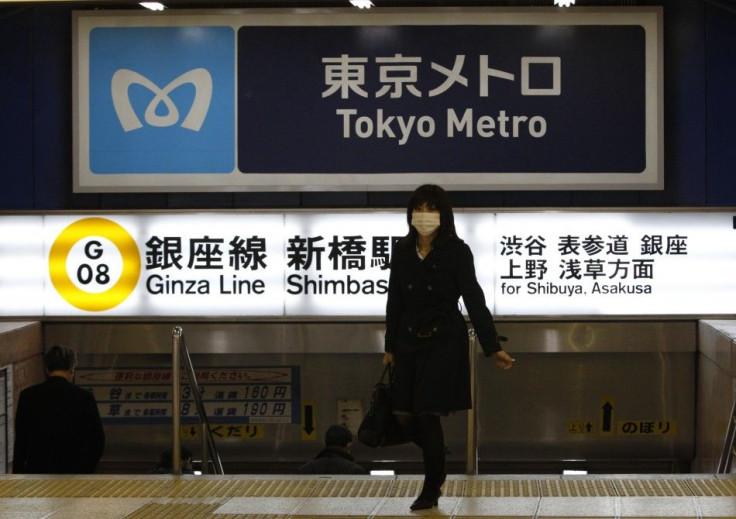 People walk at Shinbashi station in Tokyo