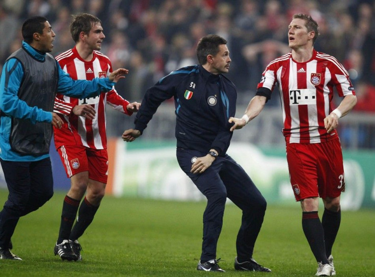 Bayern Munich's Bastian Schweinsteiger scuffles with an unidentified Inter Milan physio after their Champions League round of 16 second leg soccer match in Munich.