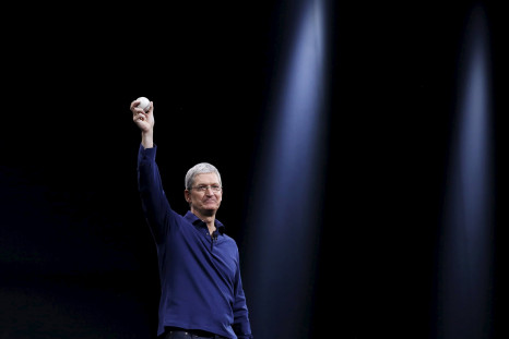 Apple CEO Tim Cook holds up a baseball as he delivers his keynote address at WWDC 2015