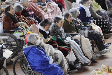 People on their wheelchairs rest at an evacuation centre in Kesennuma