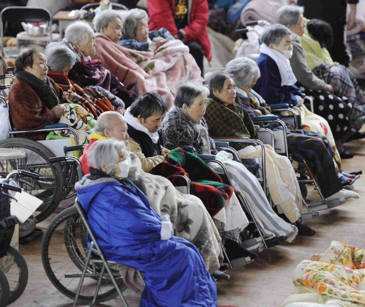 People on their wheelchairs rest at an evacuation centre in Kesennuma