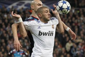 Real Madrid's Benzema is grabbed by Olympique Lyon's Cris during their Champions League soccer match in Madrid.