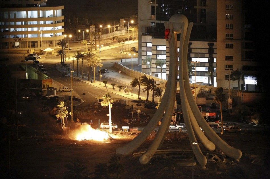 Burning tents are seen in Pearl Square in Bahrains capital Manama after security forces evacuated anti-government protesters.