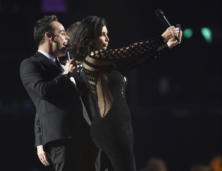 [8:47] Kim Kardashian poses for a selfie with presenters Ant and Dec at the BRIT music awards at the O2 Arena in Greenwich