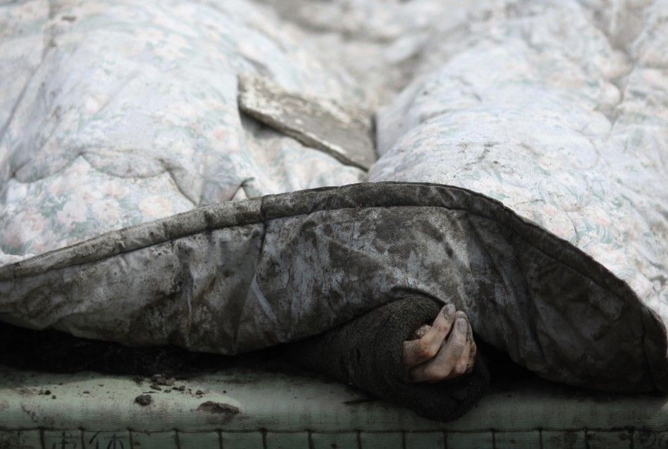 The body of a victim is covered with a blanket after it was retrieved from the rubbles of Rikuzentakat, days after the area was devastated by a magnitude 9.0 earthquake and tsunami March 17, 2011. 