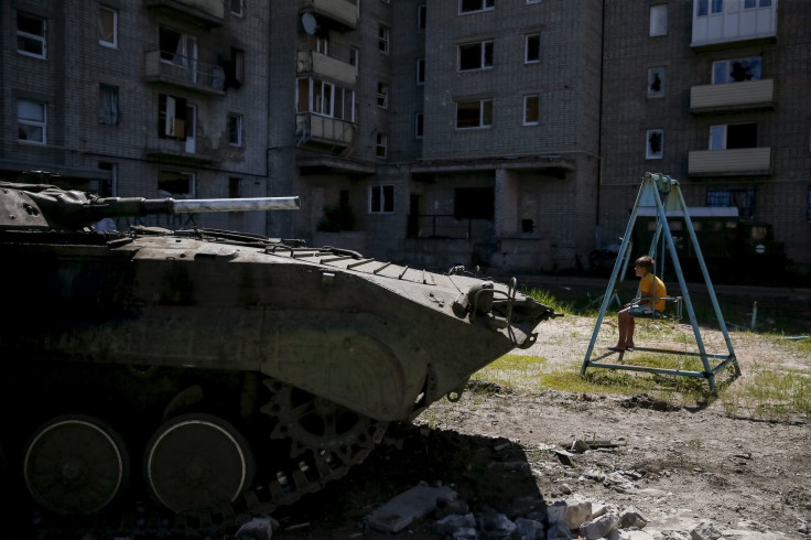 A boy sits on a swing in Avdeyevka near Donetsk.