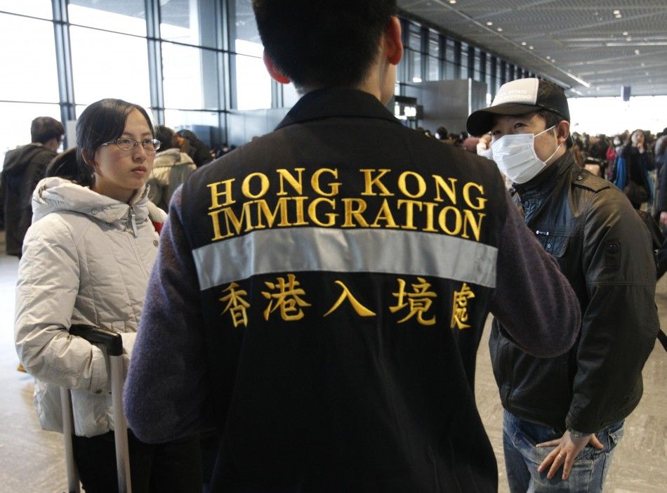 An official from Hong Kongs immigration department helps Chinese nationals to board a flight at Narita airport in Tokyo March 17 2011. Chinas embassy has set-up a help desk at Narita airport to help its nationals evacuate Tokyo, following last weeks ea
