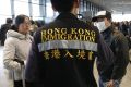 An official from Hong Kong's immigration department helps Chinese nationals to board a flight at Narita airport in Tokyo March 17 2011. China's embassy has set-up a help desk at Narita airport to help its nationals evacuate Tokyo, following last week's ea