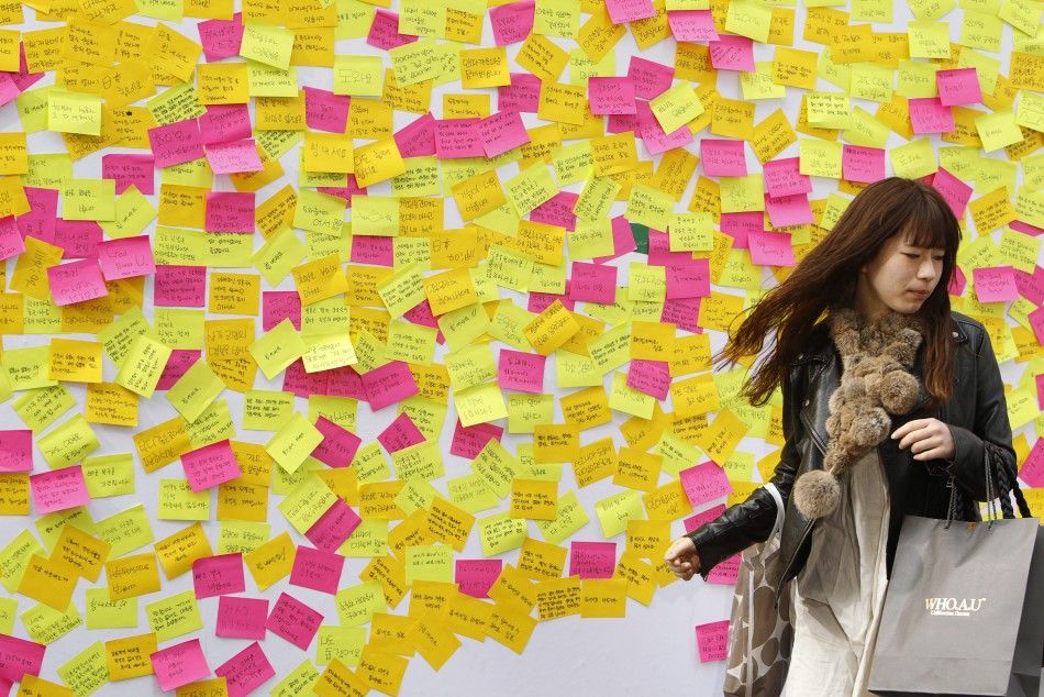 A woman walks away from a message wall after writing a message to the victims of last weeks earthquake and tsunami in Japan in central Seoul March 16, 2011.