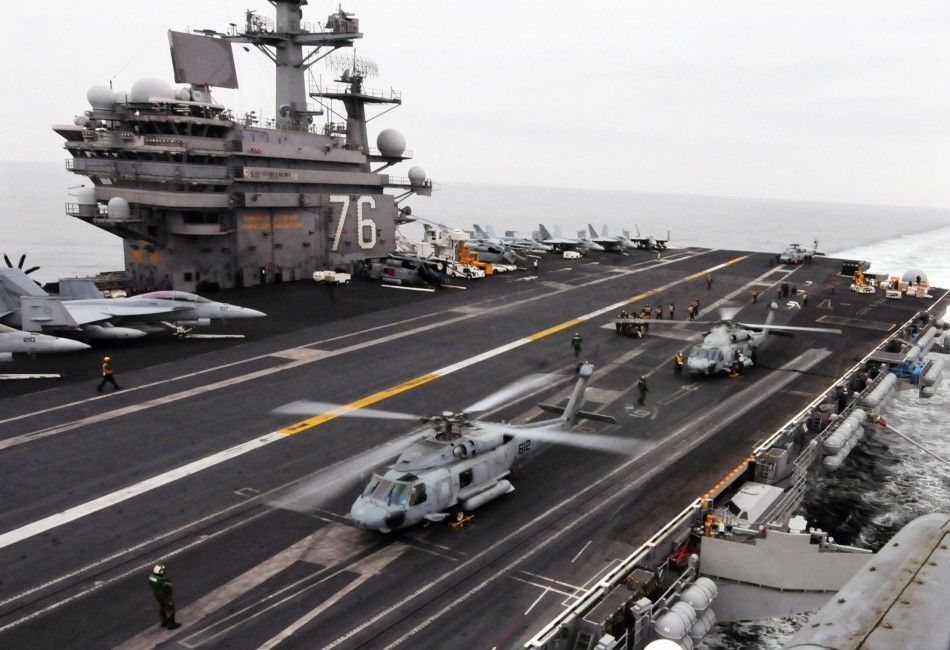 Helicopters on aircraft carrier prepare to deliver supplies