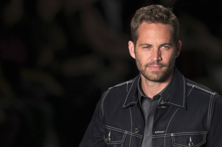 [12:21] U.S. actor Paul Walker presents a creation from Colcci's 2013/2014 summer collection during Sao Paulo Fashion Week