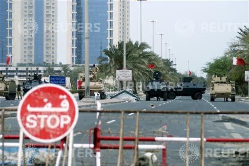 Armoured vehicles belonging to Gulf Cooperation Council military forces guard the entrance to Pearl Square in Manama