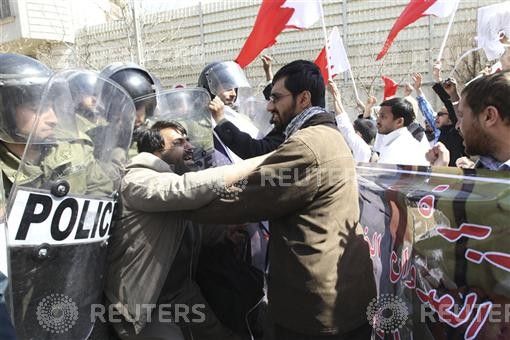 A man tries to push through police lines in front of the Saudi embassy in Tehran