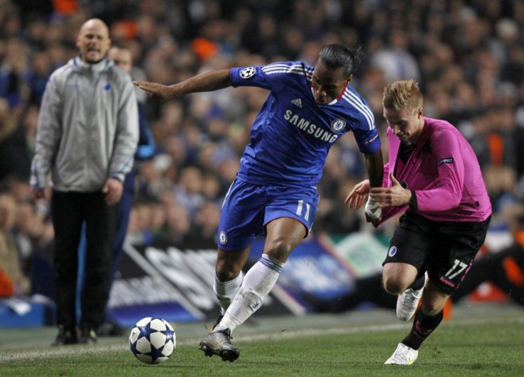 Chelsea's Drogba is challenged by FC Copenhagen's Oscar Wendt during their Champions League round of 16 second leg soccer match at Stamford Bridge in London.