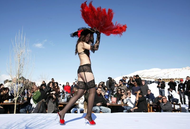 A model presents a creation for K-Lynn lingerie during a snow fashion show in Faqra
