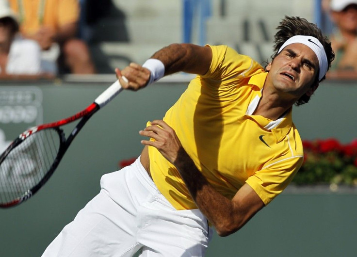 Federer serves to Wawrinka during their quarter-final match at the Indian Wells ATP tennis tournament in Indian Wells.