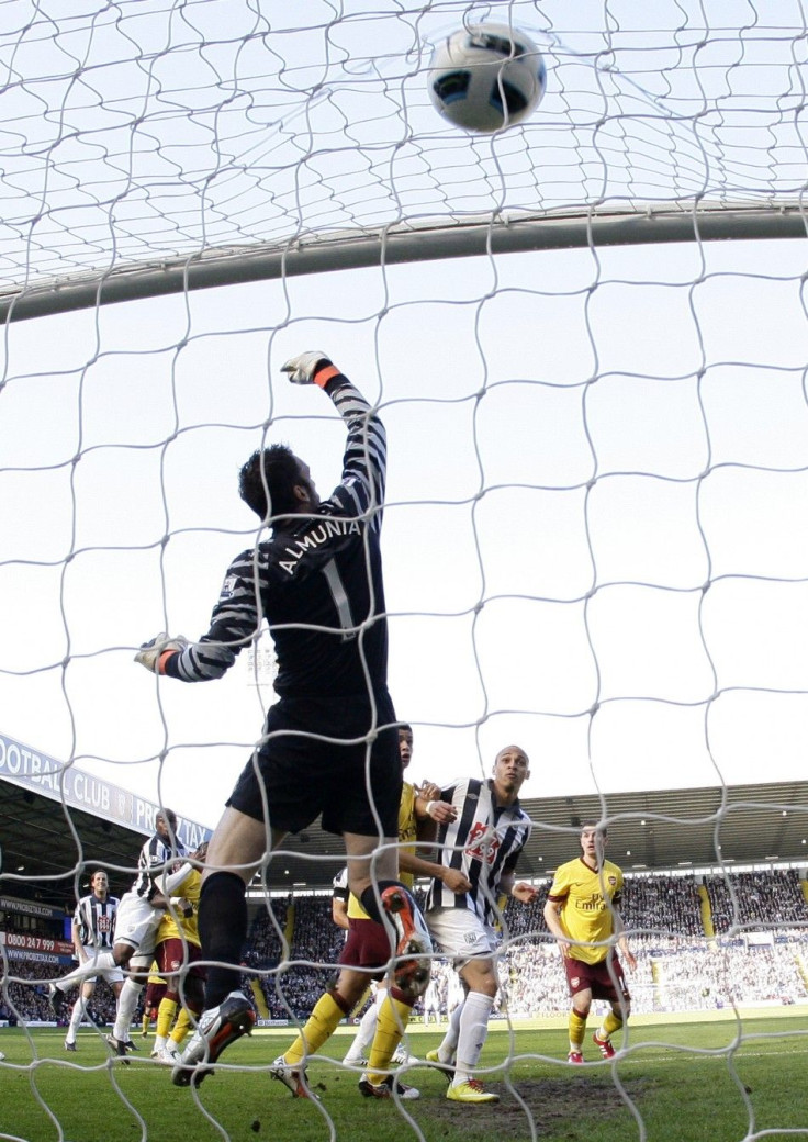 West Bromwich Albion's Reid scores past Arsenal's Almunia during their English Premier League soccer match at The Hawthorns.