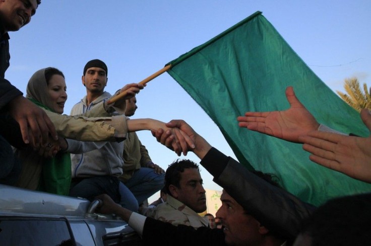 Aisha Gaddafi, daughter of Libya's leader Muammar Gaddafi, shakes hands with supporters at Bab Al-Aziziyah in Tripoli