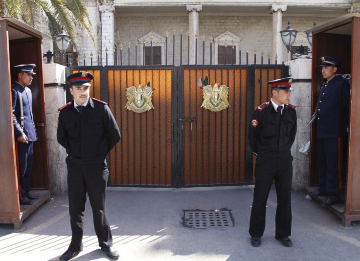 Guards keep watch outside the Interior Ministry at Marjeh square in central Damascus