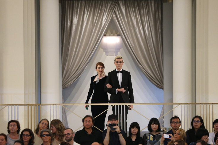 [8:07] Actress Julianne Moore (L) presents a creation by German designer Karl Lagerfeld accompanied by Gabriel Day Lewis as part of his Haute Couture Fall Winter 2015/2016 fashion show for French fashion house Chanel 
