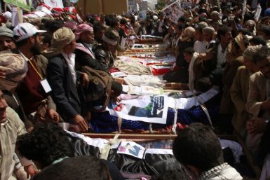 Mourners gather around the coffins of anti-government protesters during a funeral in Sanaa March 20, 2011. 
