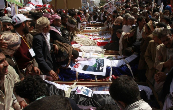 Mourners gather around the coffins of anti-government protesters during a funeral in Sanaa March 20, 2011. 