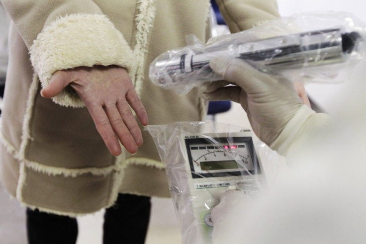 Yumi Sugiura, who evacuated from Iitate town in Fukushima, holds out her hand to be screened for traces of nuclear radiation at a welfare center in Yamagata, northern Japan March 20, 2011, nine days after the devastating earthquake and tsunami