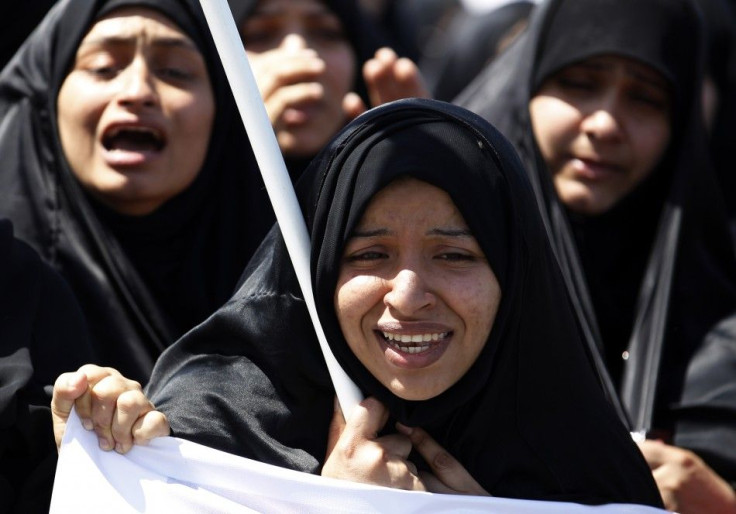 The sister of Abdulrusul Hajair cries during his funeral in the village of Buri