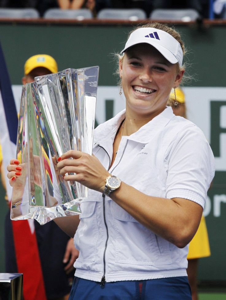 Wozniacki of Denmark holds the winners trophy after defeating Bartoli of France following the women's final of the Indian Wells WTA tennis tournament in Indian Wells.