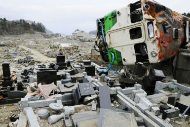 A train car swept by a tsunami lies in a heavily damaged cemetery in Onagawa, Miyagi Prefecture, northeastern Japan