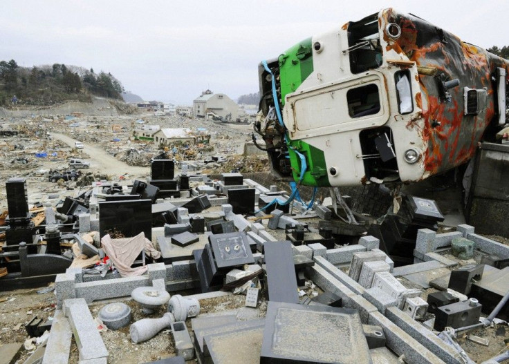 A train car swept by a tsunami lies in a heavily damaged cemetery in Onagawa, Miyagi Prefecture, northeastern Japan