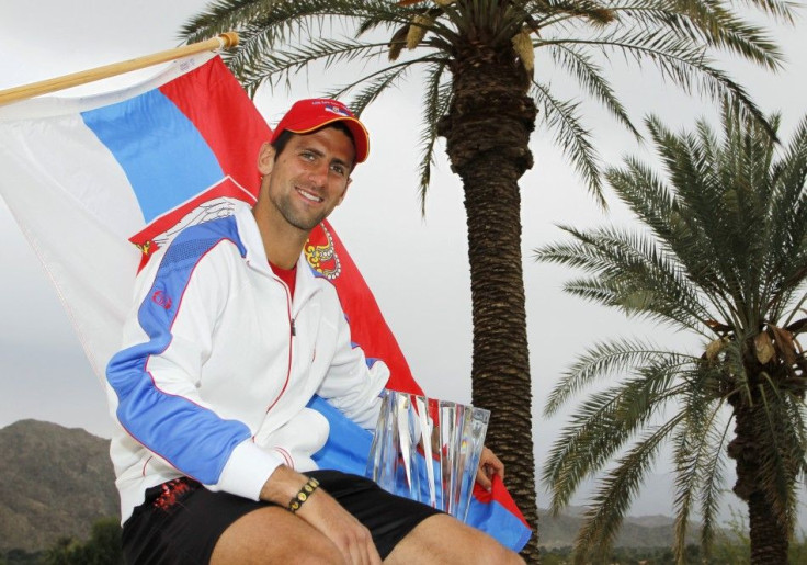 Djokovic of Serbia poses with his trophy after defeating Nadal of Spain to win the men's final of the ATP tennis tournament in Indian Wells.