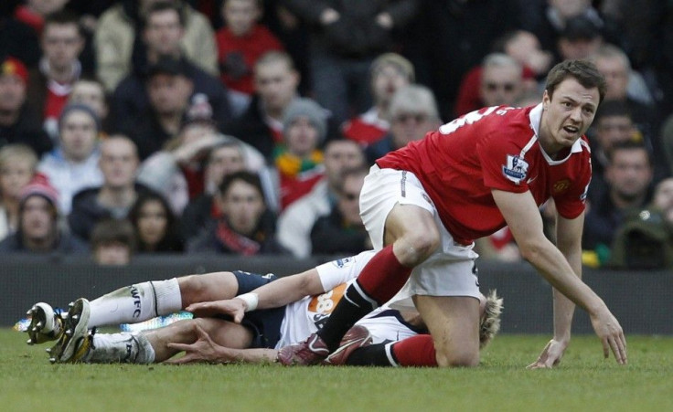 Manchester United's Evans reacts after a challenge on Bolton Wanderers' Holden during their English Premier League soccer match at Old Traffortd in Manchester.