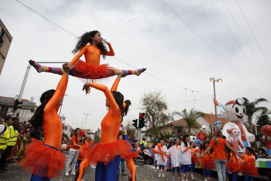 Performers take part in an annual parade for Purim in Holon