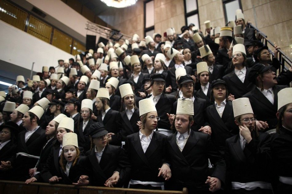 Ultra-Orthodox Jewish men dance while celebrating the Jewish holiday of Purim at a synagogue in Bnei Brak