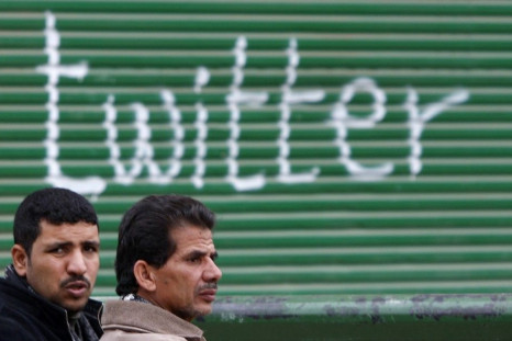 Opposition supporters talk near graffiti referring to the social networking site &quot;Twitter&quot; in Tahrir Square in Cairo February 5, 2011.