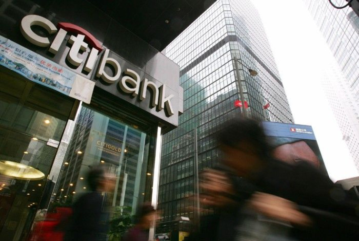 People walk past a Citibank branch in Hong Kong
