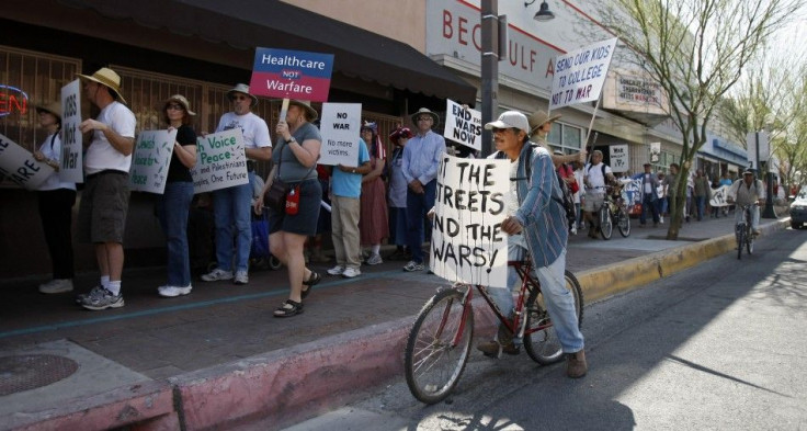 People protest in the streets regarding the United States' actions in Libya, in Tucson, Arizona