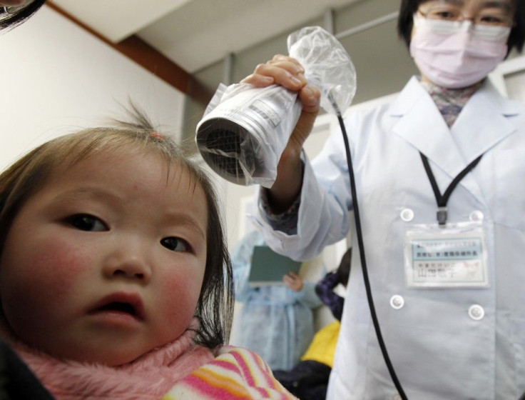 A girl, from Minamisoma in Fukushima, undergoes a screening test for signs of nuclear radiation by a doctor at a health center in Yonezawa