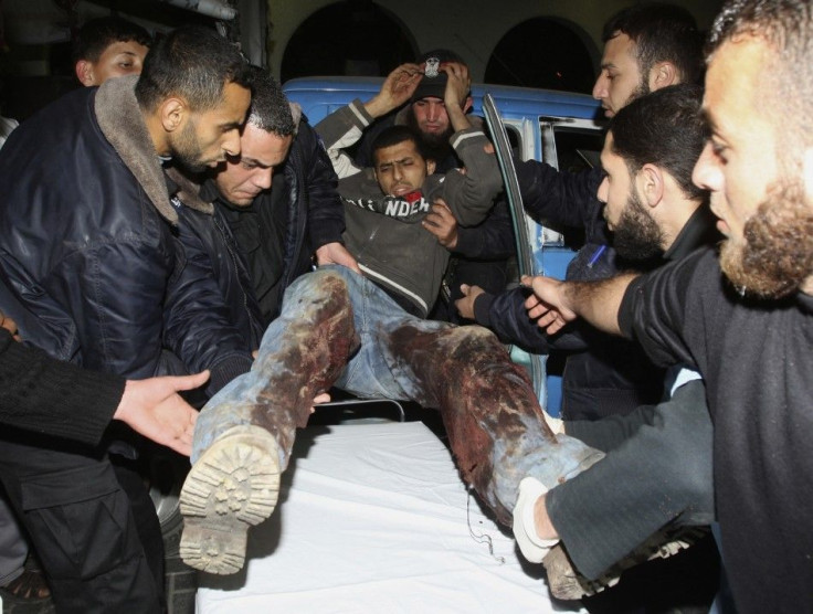 Palestinians carry a wounded youth into Al-Shifa hospital in Gaza City