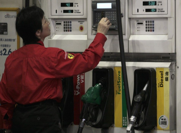 A worker checks the price of fuel at a gas station in Hong Kong January 14, 2011. 