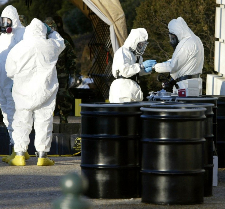 Officials dressed in protective suits prepare to enter the closed Russell Senate Office Building on Capitol Hill, to retreive mail that could be contaminated, February 4, 2004.
