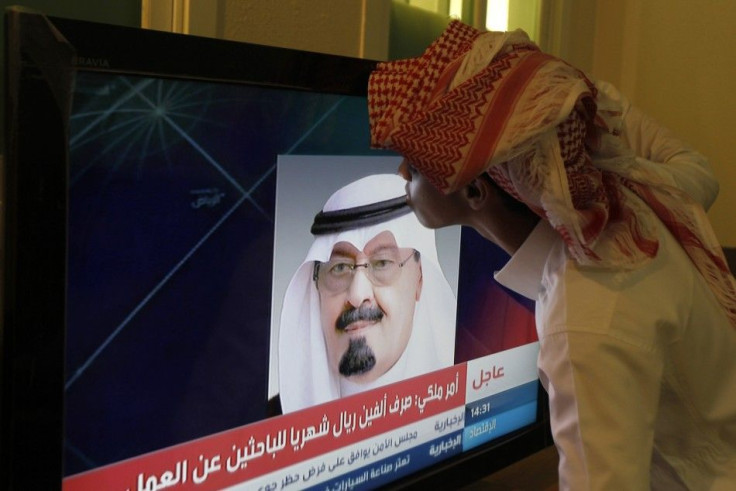 Ahmed Abdullah kisses a television screen showing an image of Saudi King Abdullah as he addressed the nation in Riyadh